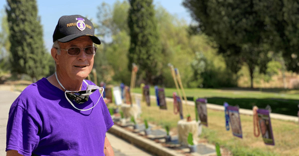 Leonard Tavernetti stands in front of grave markers in Redlands