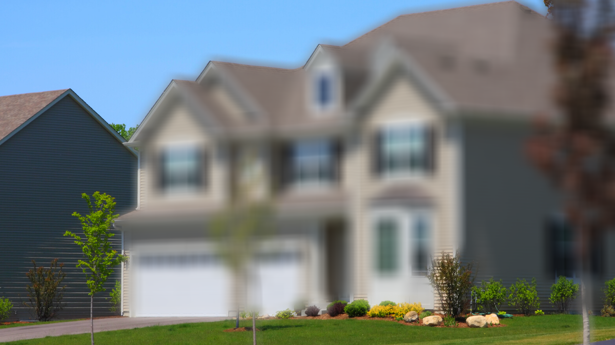 A blurred image of a home in a residential area.