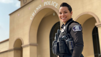 Chino Police Officer Jessica Asbee posing in front of the Chino Police Department.