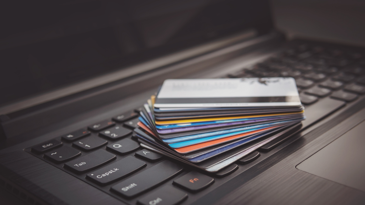 Credit cards piled up on a laptop keyboard